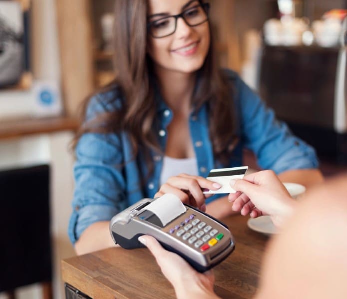 A woman is paying for something with her credit card.